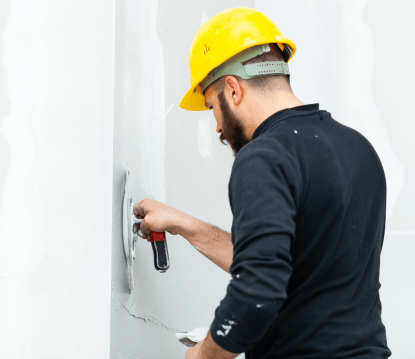 worker-plastering-gypsum-board-wall